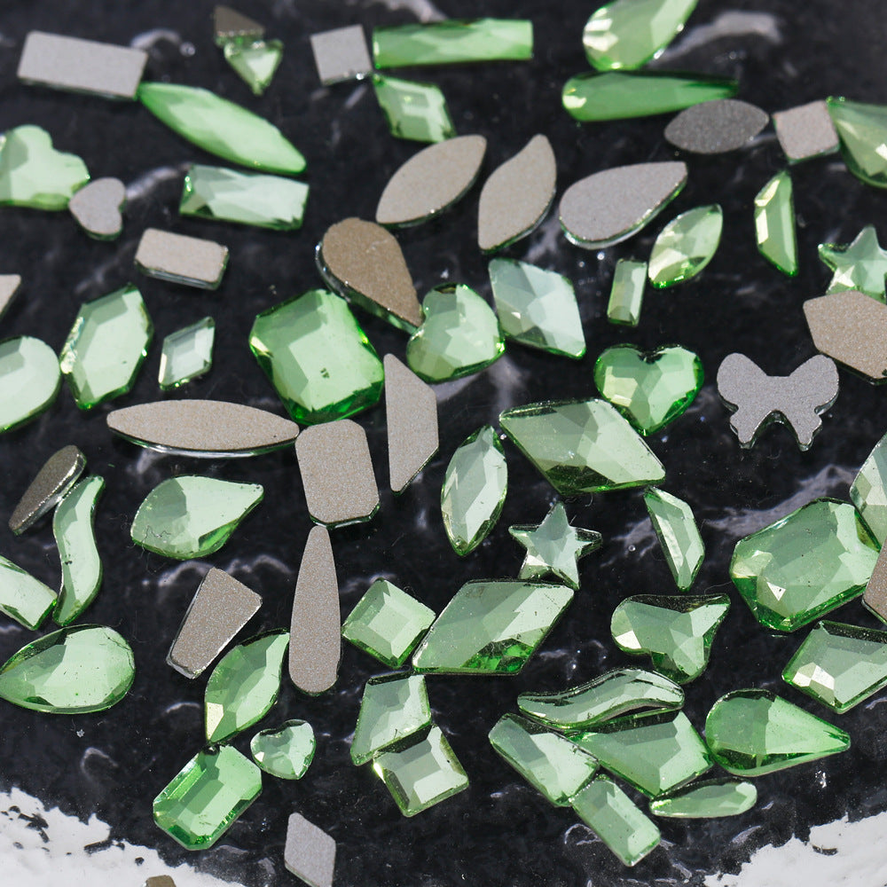 Nail art featuring a mix of unique shapes, flat-bottomed glass rhinestones, ultra-sparkling light green gel nail art, trendy and Instagram-worthy.