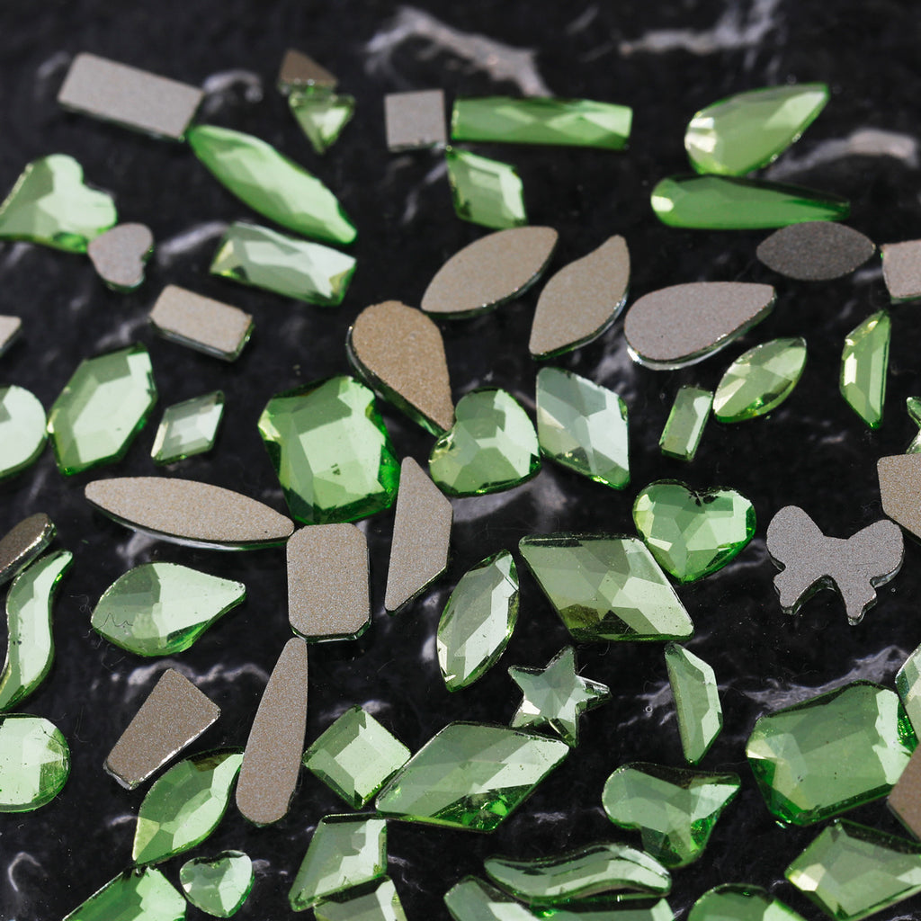 Nail art featuring a mix of unique shapes, flat-bottomed glass rhinestones, ultra-sparkling light green gel nail art, trendy and Instagram-worthy.