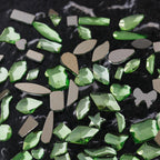 Nail art featuring a mix of unique shapes, flat-bottomed glass rhinestones, ultra-sparkling light green gel nail art, trendy and Instagram-worthy.